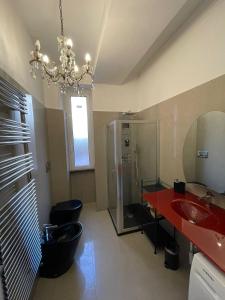 a bathroom with a red sink and a shower at Design House Monti in Rome