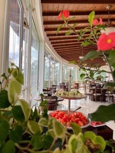 a room with tables and chairs and some plants at Bellwood Hills Resort & Spa in Kandy