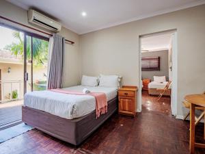a bedroom with a large bed and a window at Carrington Guest House in Durban +63 photos