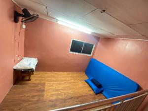 a small room with a blue bed in a room at VJ Homestay in Jasin