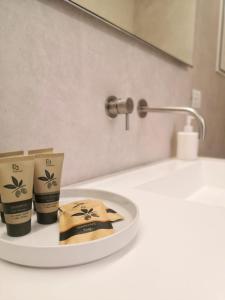 a bathroom counter with two products on a sink at "Le chic" sulla duna fronte mare in Follonica