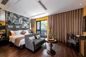 a hotel room with a bed and a couch at Hanoi Lion Boutique Hotel & Spa in Hanoi