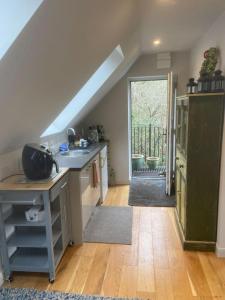 a kitchen with a sink and a door to a yard at Cosy, private, cabin suit couples looking for a retreat and business traveller, near Frieth in High Wycombe