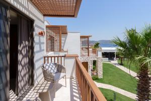a balcony with a chair and a view of the ocean at Mavi Suite Turkbuku in Golturkbuku