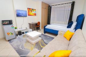 a living room with a couch and a bed at lexy homes in Ruiru