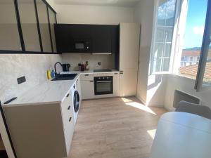 a kitchen with a sink and a dishwasher at Joli studio en centre-ville in Corte