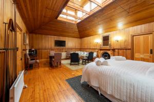 a bedroom with a large bed and a dining room at Craignair Guest House in Mount Macedon