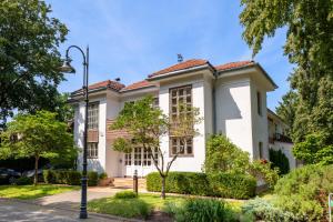 a white house with a red roof at Vila Šilelis in Palanga