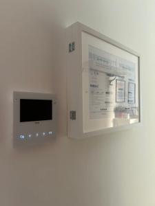 a microwave on a wall next to a wall at Casa aMare in Chioggia +4 photos