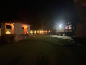 a golf course at night with a building and lights at Heritage House Shillong in Shillong