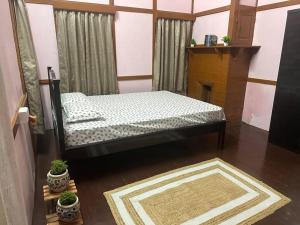 a bedroom with a bed in a room with a fireplace at Heritage House Shillong in Shillong