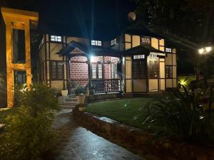a house at night with lights in front of it at Heritage House Shillong in Shillong