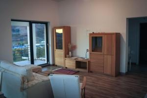 a living room with a couch and a dresser at Zöld Liget Apartman House in Odorheiu Secuiesc
