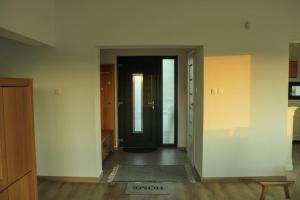 an empty room with a door and a hallway at Zöld Liget Apartman House in Odorheiu Secuiesc +4 photos