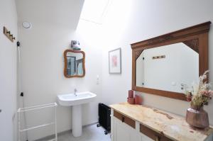 a bathroom with a sink and a mirror at Le sourire - Maison avec Jardin, Bureau & BBQ in Rochefort +40 photos