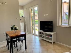 a living room with a table and a television at Elicriso in Barga