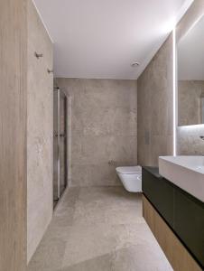 a bathroom with a sink and a tub and a toilet at Tuck Inn in Larnaca