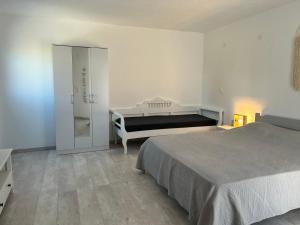 a bedroom with two beds and a walk in closet at Olive House in Márpissa