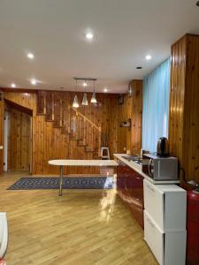 a kitchen with wooden walls and a table in a room at Volna in Odesa