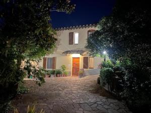 a large house with a red door at night at VILLA IL TUFO in Siena