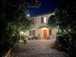 a large white house with a door at night at VILLA IL TUFO in Siena