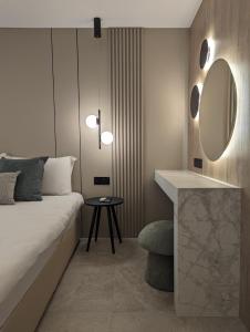 a bedroom with a bed and a mirror and a table at Tuck Inn in Larnaca