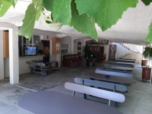 a group of tables and chairs in a room at Vila Andra in Costinesti