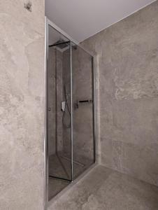 a shower with a glass door in a bathroom at Tuck Inn in Larnaca