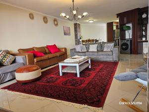 a living room with couches and a red rug at Swakopmund holiday Apartment in Swakopmund