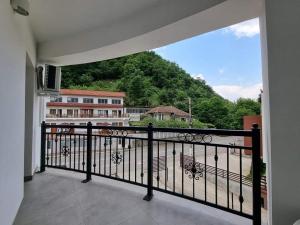 a balcony with a view of a building at Pensiunea Maty in Băile Herculane