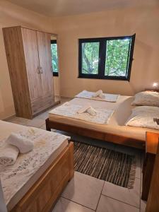 a bedroom with two beds and a window at Apartment Lavanda in Starigrad
