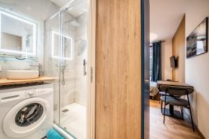 a bathroom with a washing machine in a room at Coeur vieille ville in Annecy +159 photos