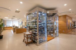 a room with a display case filled with wine bottles at Laguna Park Hotel 4Superior in Bibione