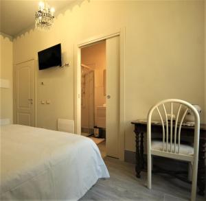 a bedroom with a bed and a table and a chair at Villa Gemma in Ravenna