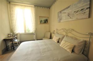 a bedroom with a white bed and a window at Villa Gemma in Ravenna