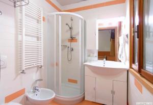 a bathroom with a sink and a shower and a toilet at Hotel Da Bepi in Lido di Jesolo