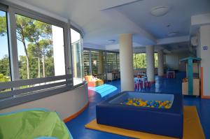 a childrens play area with a large window at Laguna Park Hotel 4Superior in Bibione