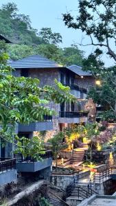 a building with stairs and trees in front of it at Kananwas Resort, Kumbhalgarh in Kumbhalgarh