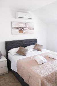 a bedroom with a bed with two pillows on it at Holiday home Bevanda in Velika Čista