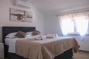 a bedroom with a bed with two towels on it at Holiday home Bevanda in Velika Čista +72 photos