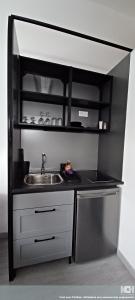 a small kitchen with a sink and a counter at Le Studio in Aubervilliers +6 photos