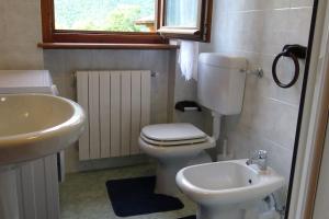 a bathroom with a white toilet and a sink at Chalet Belvedere in Costa di Serina +46 photos
