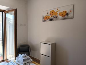 a room with a refrigerator and a picture on the wall at La casina in Caprarola +4 photos