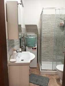a bathroom with a sink and a shower at La casina in Caprarola +4 photos