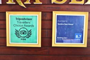 two signs on the side of a wooden wall at Sontra Sea Hotel in Danang