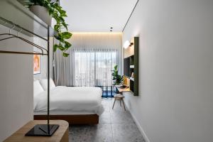 a hotel room with a bed and a desk at Hotel 48 in Beer Sheva