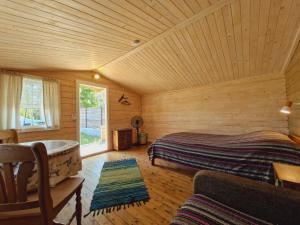 a bedroom with a bed in a wooden room at Piibelehe Guest Accommodation in Kuressaare