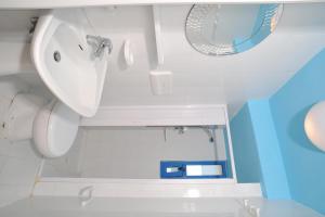 a white bathroom with a sink and a mirror at Residence Le Orchidee in Vieste