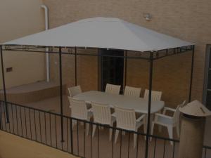 a white table and chairs on a balcony at DownTown Guest House in Lisbon