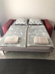 a bed with two pillows on it in a room at Apartment Petrovic Medulin in Medulin